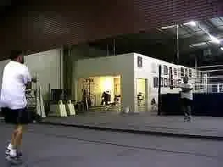 Video frame of a man jumping rope in a large indoor gym