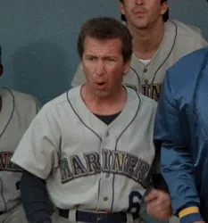 Animated reaction GIF of a baseball player in the dugout grabbing his head in amazed disbelief